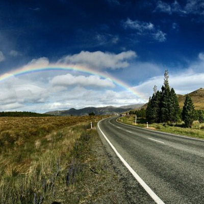 Road with rainbow in background